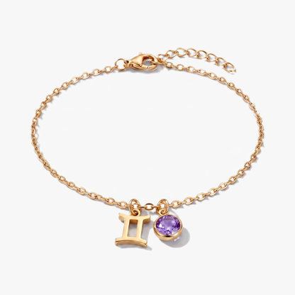 Złota bransoletka ze znakiem zodiaku Bliźniąt i kamieniem urodzeniowym aleksandrytem.