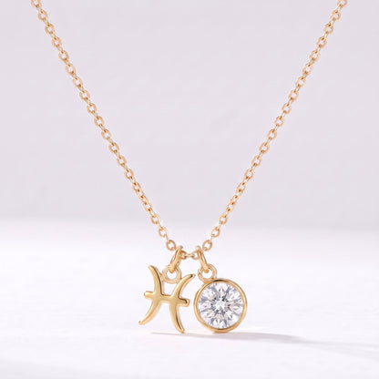 Złoty naszyjnik ze znakiem zodiaku Ryb i cyrkonią.