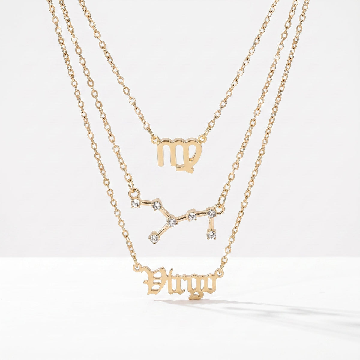 Zestaw 3 złotych naszyjników ze znakiem zodiaku Panny.